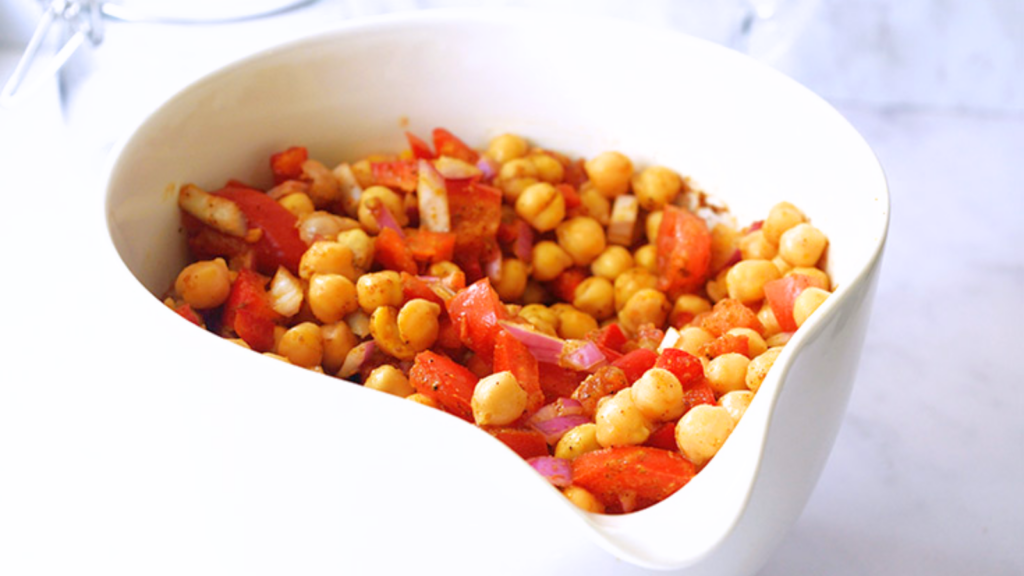 A white mixing bowl filled with Indian chickpea salad.