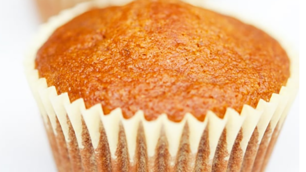 A lemon muffin against a white background.