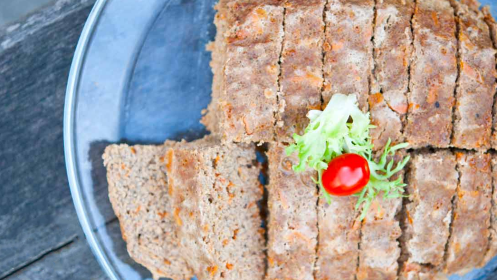 An overhead view of a slow cooker meatloaf that has been sliced.