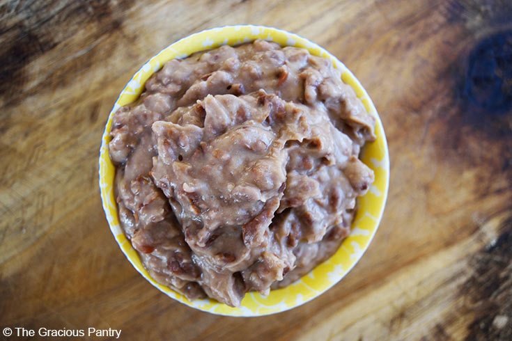 And overhead view looking down into a small bowl of refried beans in a bowl.