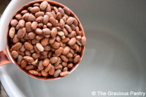 Adding dry pinto beans to a pot of water for this Refried Beans Recipe.