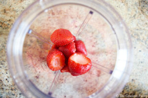 Strawberries in a blender tumbler.