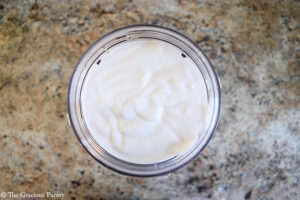 Yogurt added to a blender tumbler.