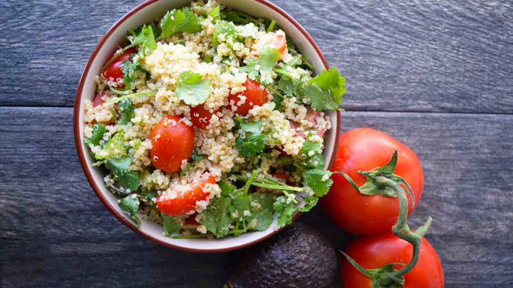 An overhead view of a bowl filled with avocado quinoa salad. 