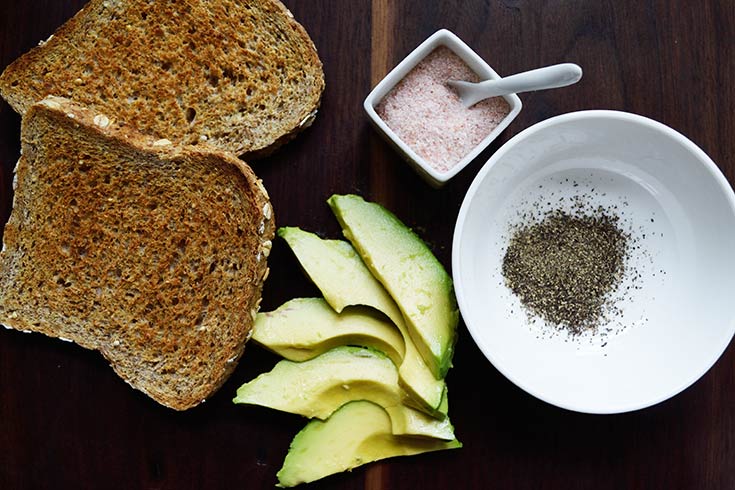 Recipe ingredients laying on a dark wood cutting board.