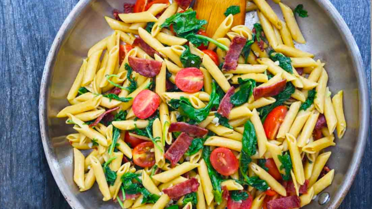 A skillet filled with baby kale pasta.
