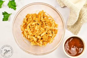 BBQ sauce mixed into shredded chicken.