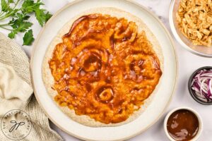 BBQ sauce spread over a pita bread.