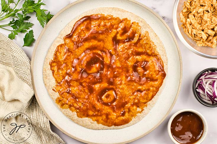 BBQ sauce spread over a pita bread.