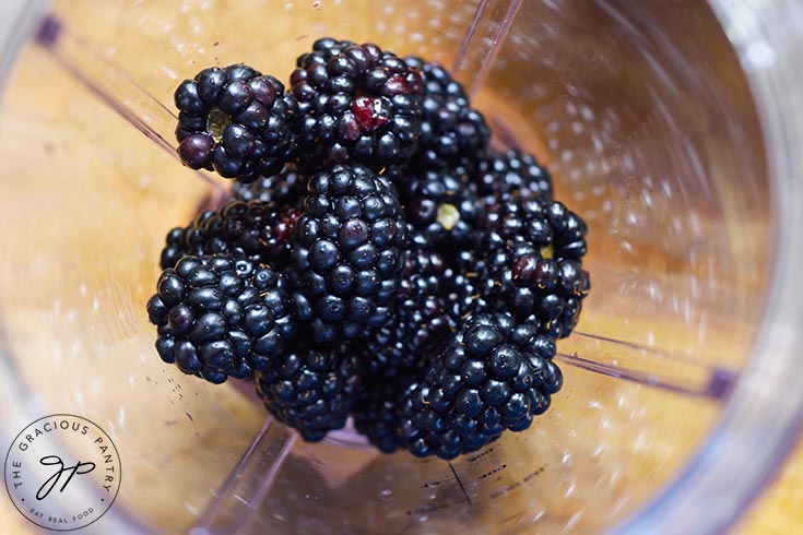Fresh blackberries in a blender tumbler.
