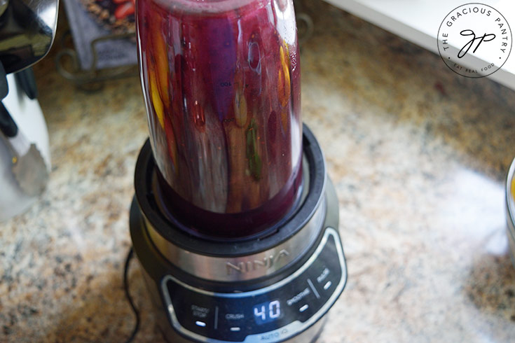 Blending fresh blackberries in a blender.