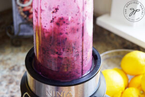 Blending blueberries in a blender.