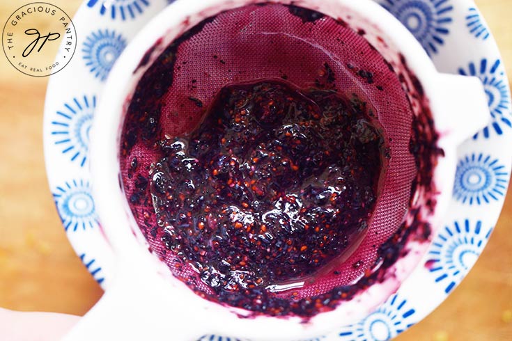 Leftover blueberry pulp in a mesh strainer.