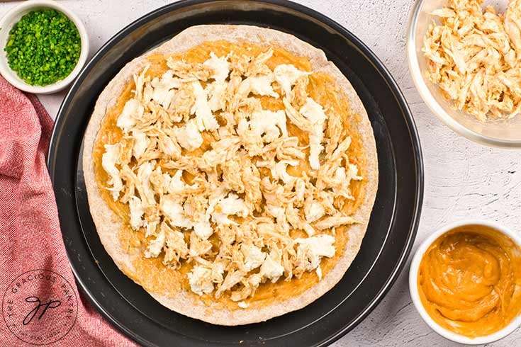 Shredded chicken added to the pizza.