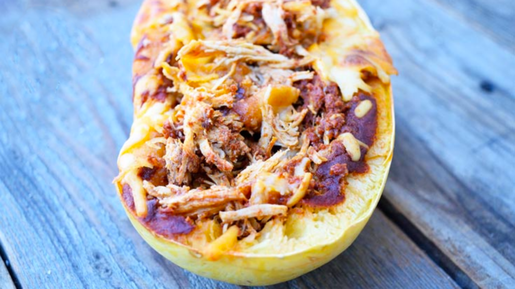 A half a spaghetti squash filled with chicken enchilada filling.