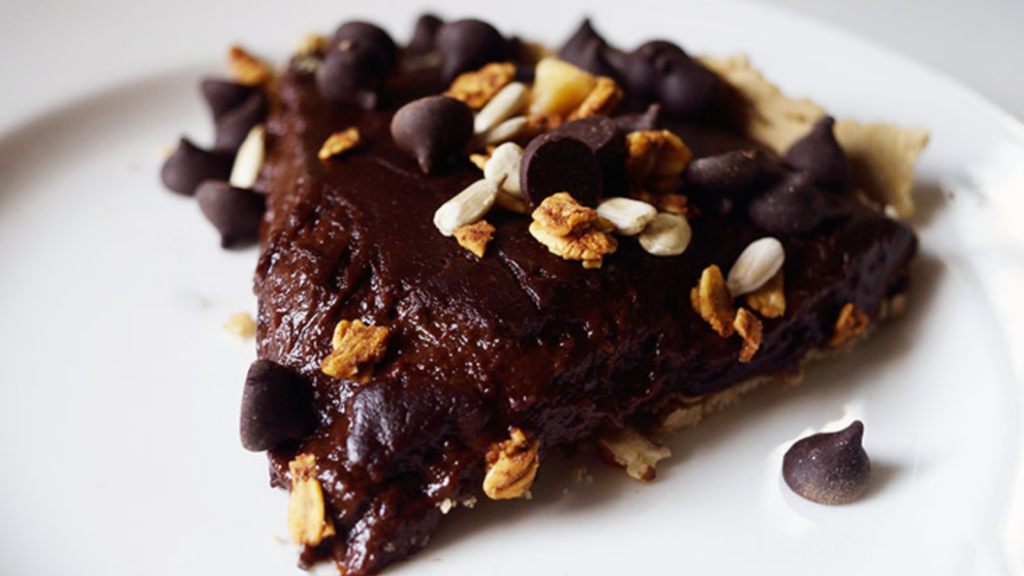 A single slice of chocolate pie on a white plate.