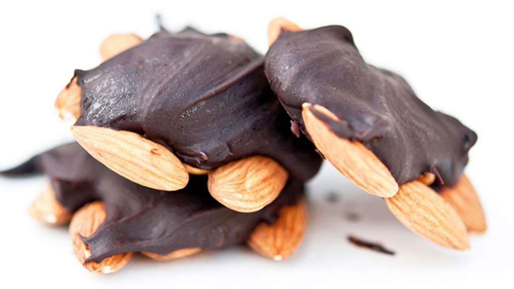 A stack of three chocolate turtles on a white background.