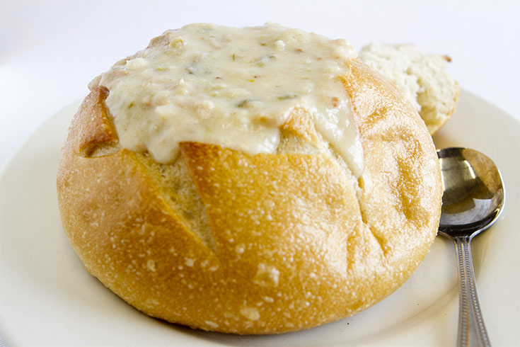 A bread bowl full of clam chowder.