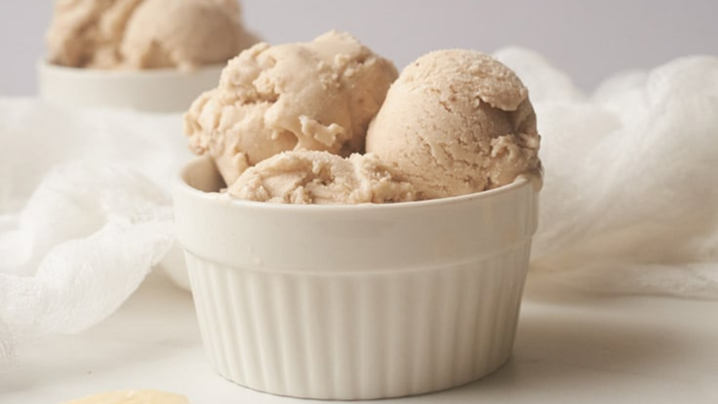 A white bowl filled with scoops of coconut n'ice cream.