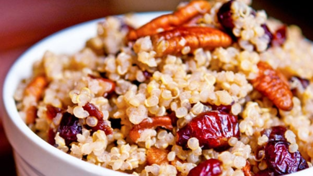 A white bowl filled with cranberry pecan quinoa.