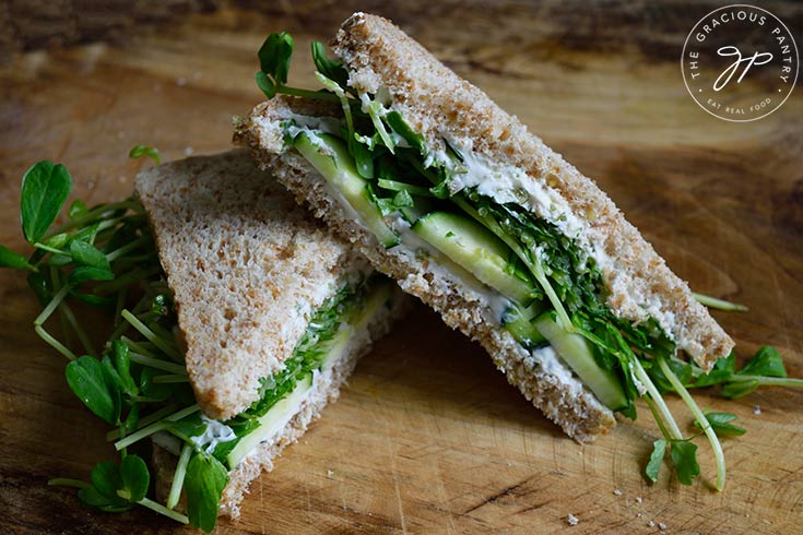 A finished cucumber sandwich cut in half.