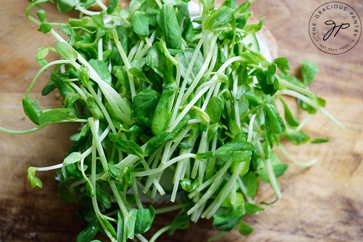 Microgreens laid over cucumbers.