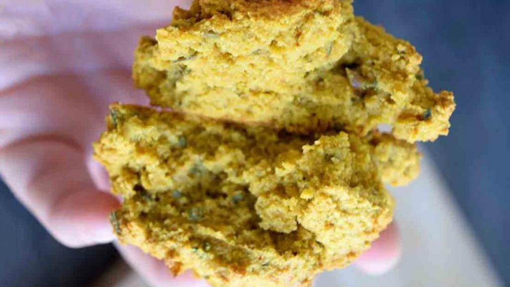 A low carb drop biscuit broken in half, held in a hand.