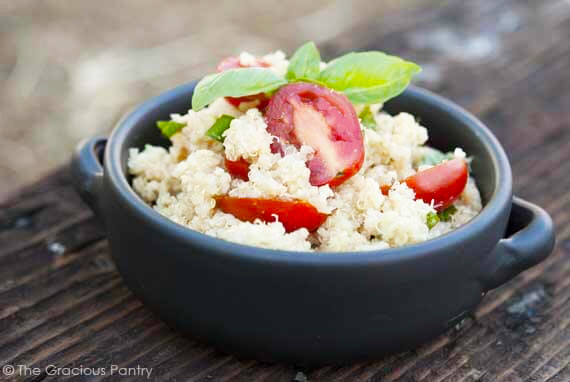 A horizontal view of a black crock filled with Garlic Parmesan Quinoa.