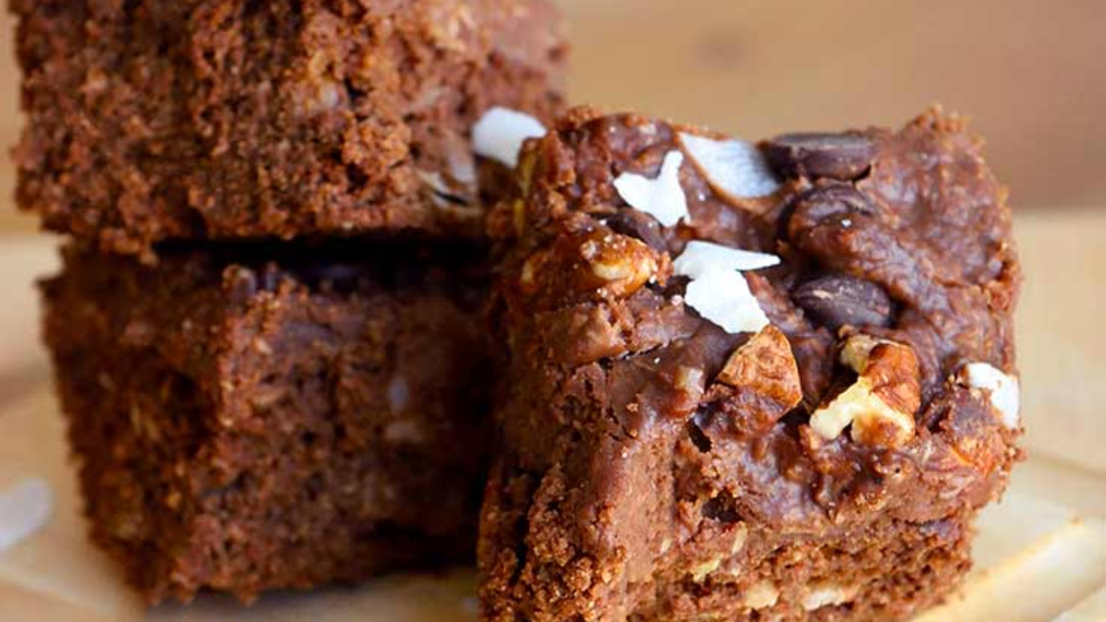 An up close shot of three squares of german chocolate brownies.