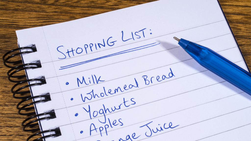 A shopping list written in a notebook.