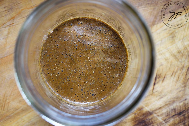 An overhead view looking down into a jar containing Healthy Balsamic Vinaigrette.