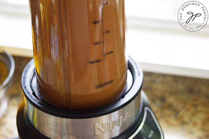 Blending the Healthy Balsamic Vinaigrette Recipe ingredients in a blender.