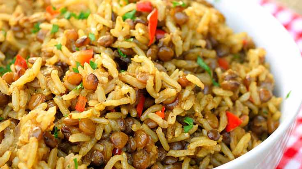 A closeup of a white bowl filled with Instant Pot Lentils and Rice.