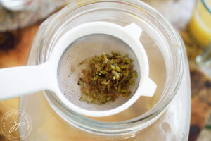 Strained lavender flowers in a strainer.