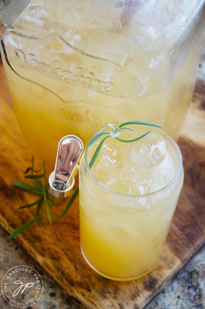 A glass of Lavender Lemonade garnished with fresh lavender.