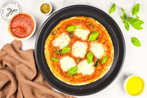 Fresh basil leaves added to the pizza just after taking it out of the oven.