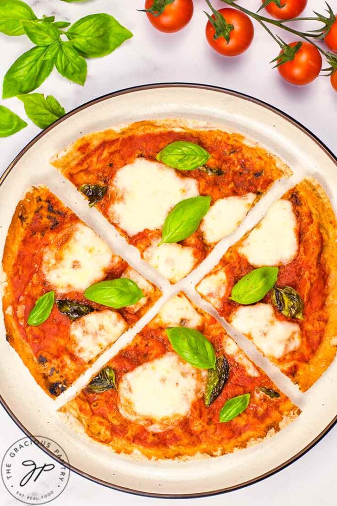 A sliced Margherita Pizza on a platter.