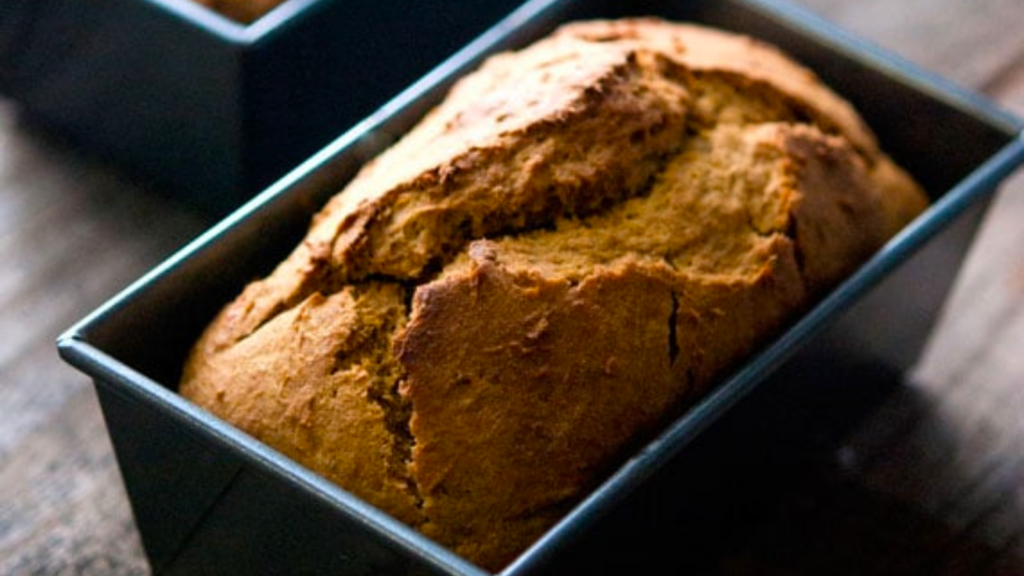 A small loaf of pumpkin banana bread in a mini loaf pan.