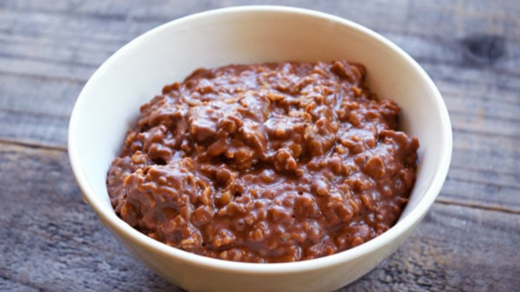 A white bowl holds a serving of peanut butter cup oatmeal.