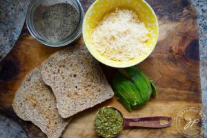 Pesto Avocado Toast Recipe ingredients collected onto a cutting board.