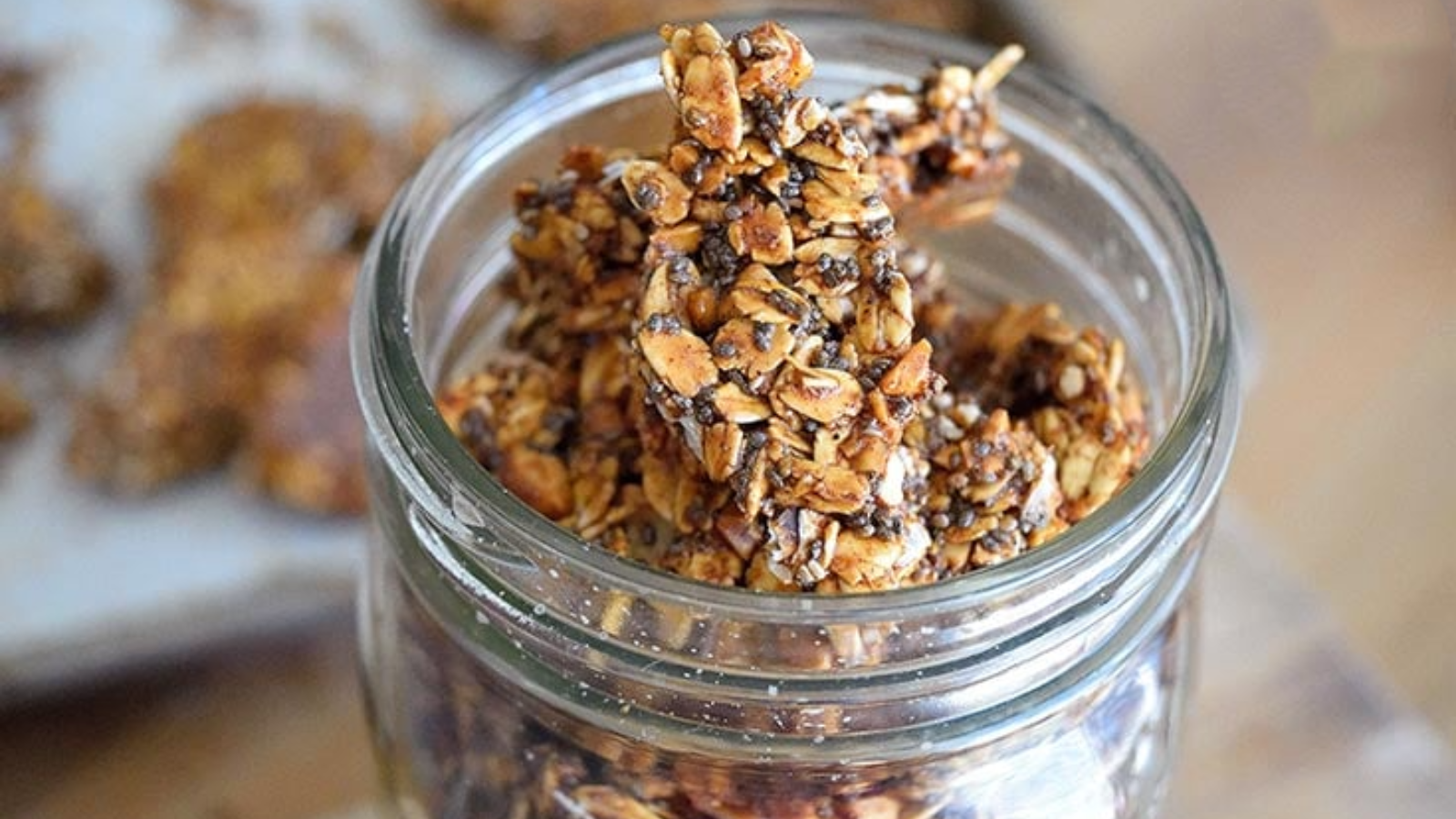 Pumpkin spice granola bark pieces in a glass jar.