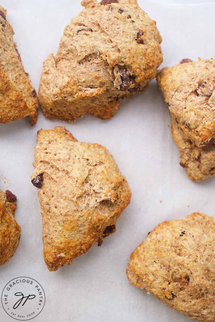 An overhead view of Raisin Scones on a parchment-lined baking pan.