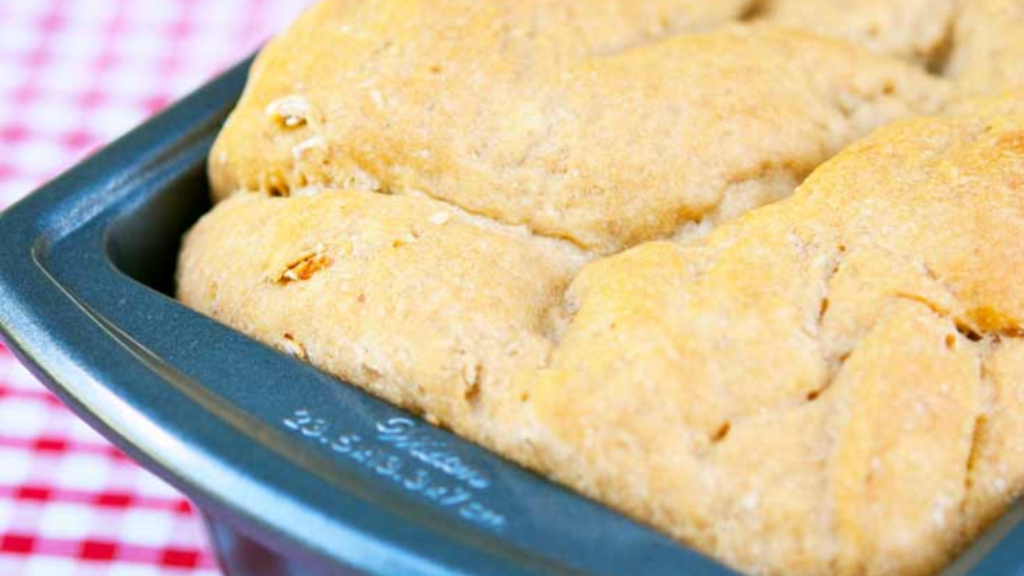 An up close view of a loaf of bread in a bread pan.
