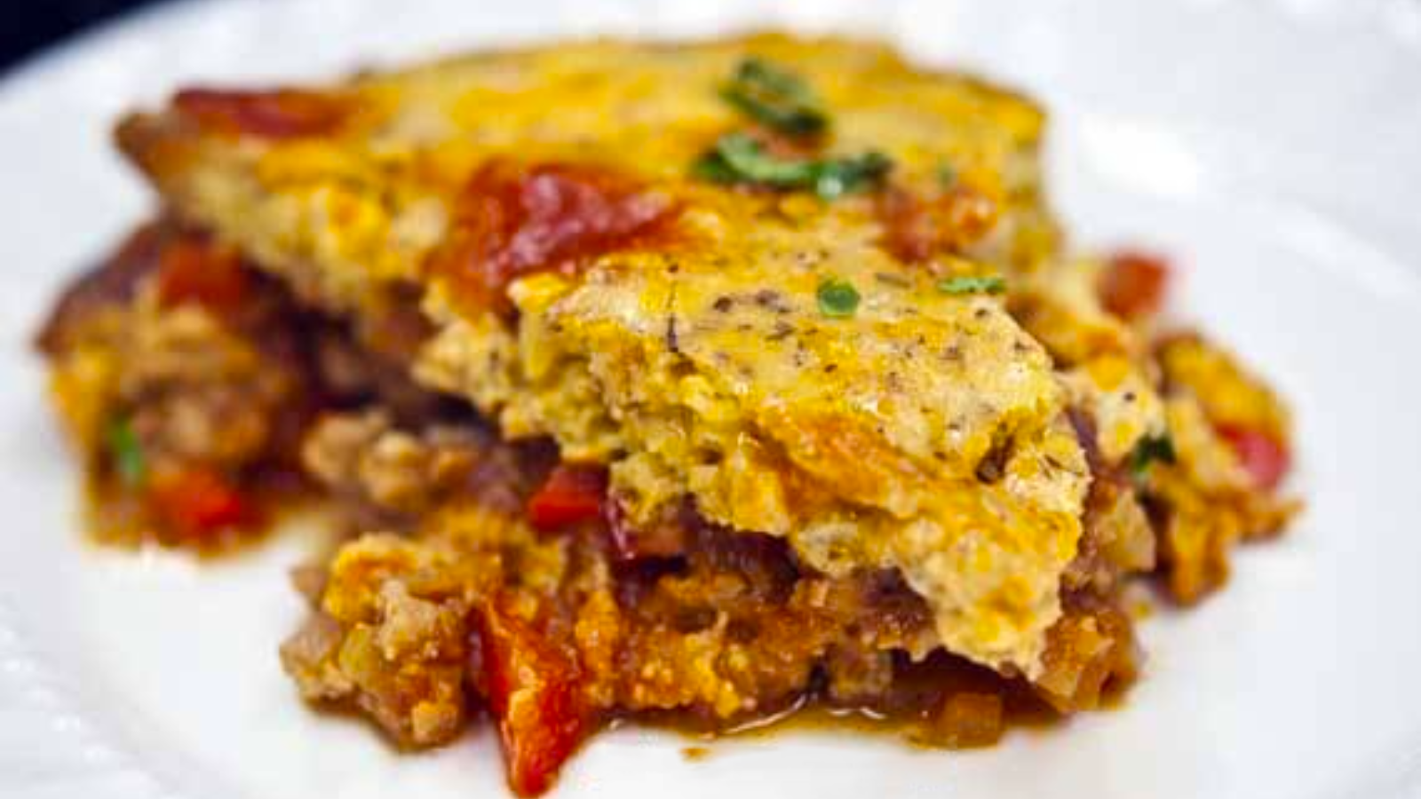 A slice of sloppy joe skillet casserole on a white plate.