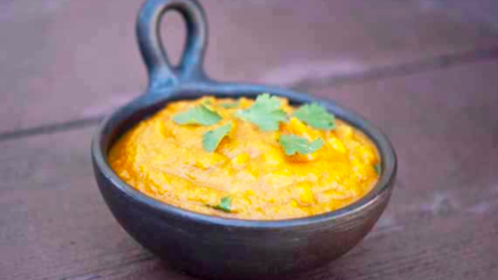 A black crock filled with southwestern butternut squash soup.