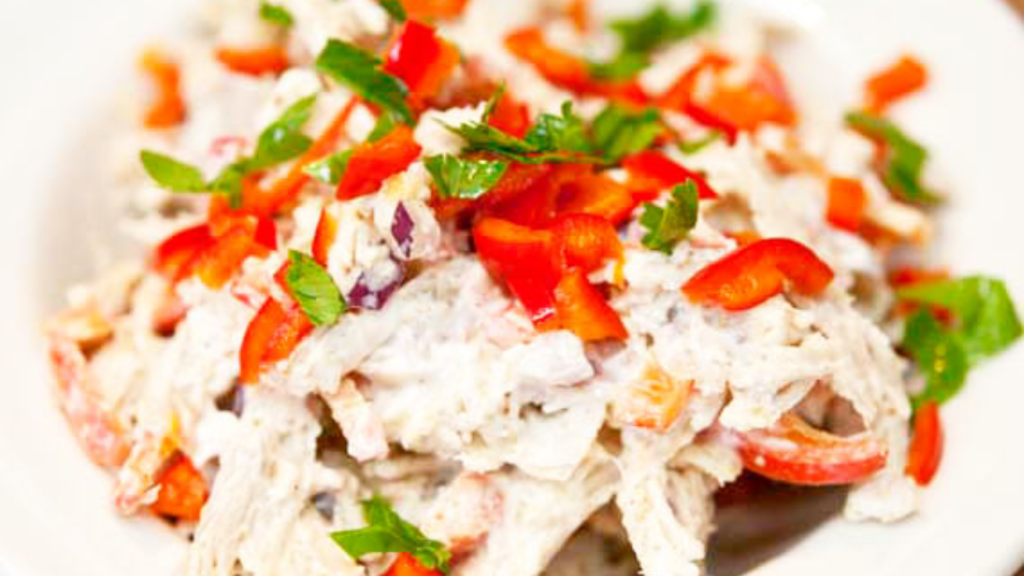 A closeup of a white bowl filled with southwestern chicken salad.