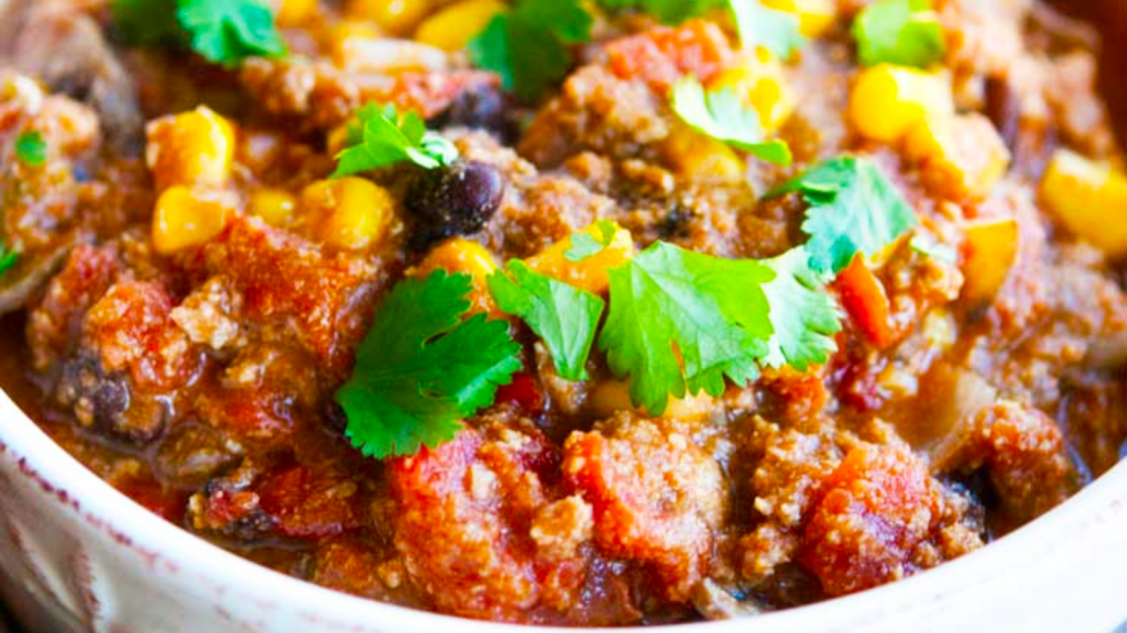 A closeup of a white bowl filled with southwestern turkey chili.