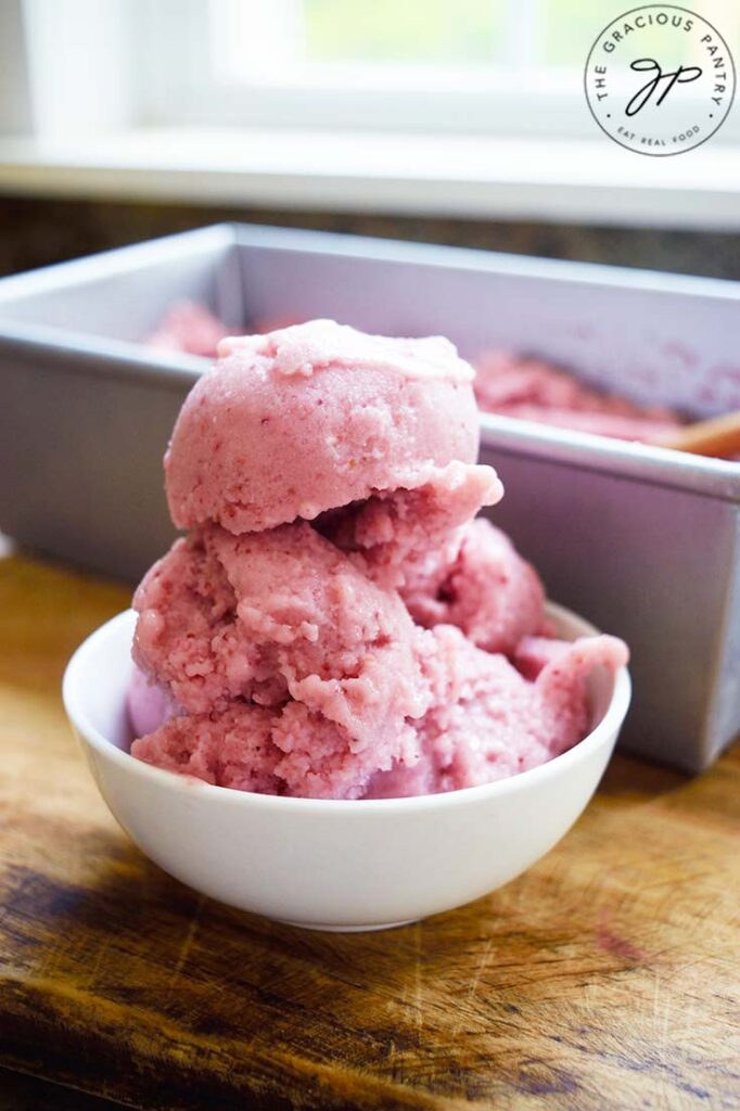 A small white bowl holds several scoops of Strawberry N'ice Cream.