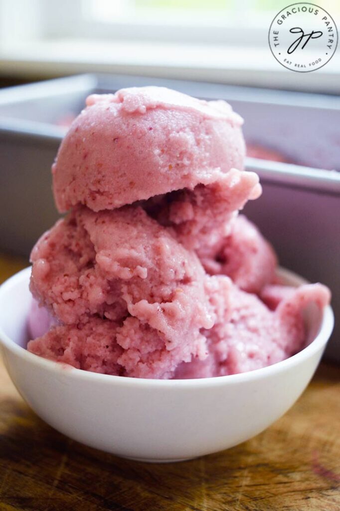 A closeup of a small white bowl with several scoops of Strawberry N'ice Cream in it.
