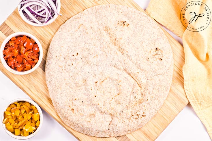 A pita bread on a cutting board.